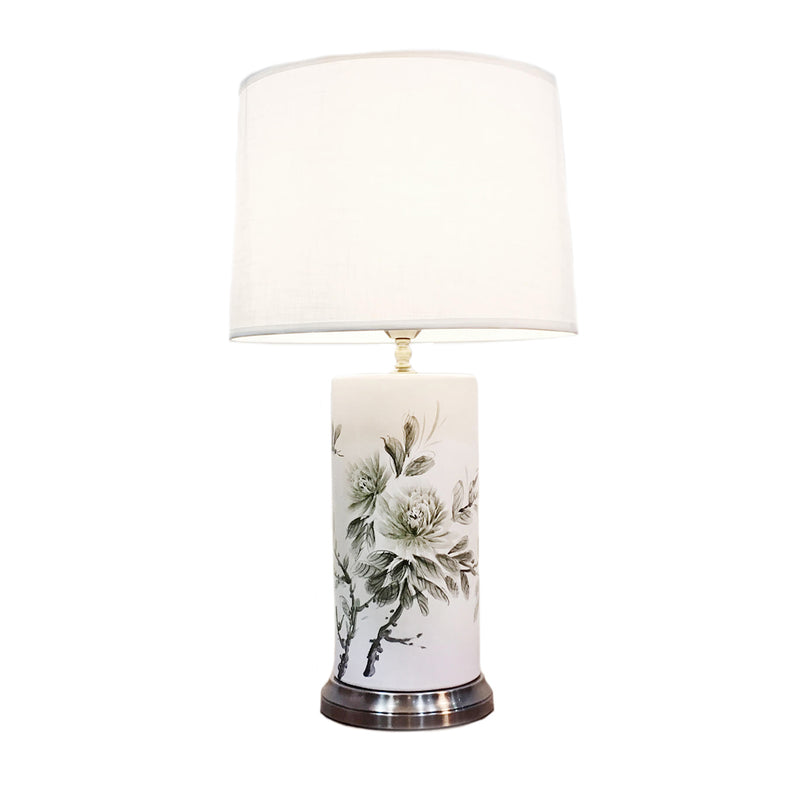 Tall cylindrical ceramic table lamp with white background